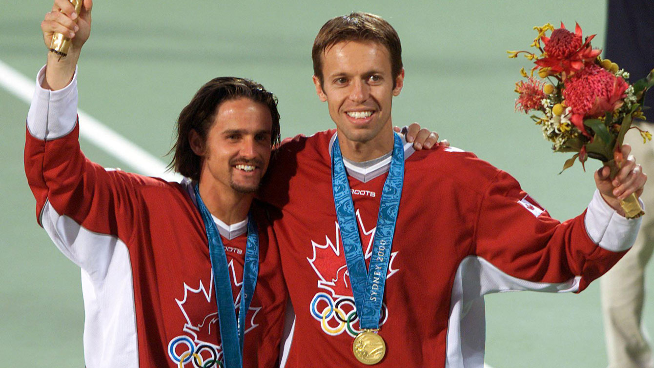 Sebastien Lareau and Daniel Nestor celebrate their men's doubles Olympic gold at Sydney 2000. (CP PHOTO/Ryan Remiorz)