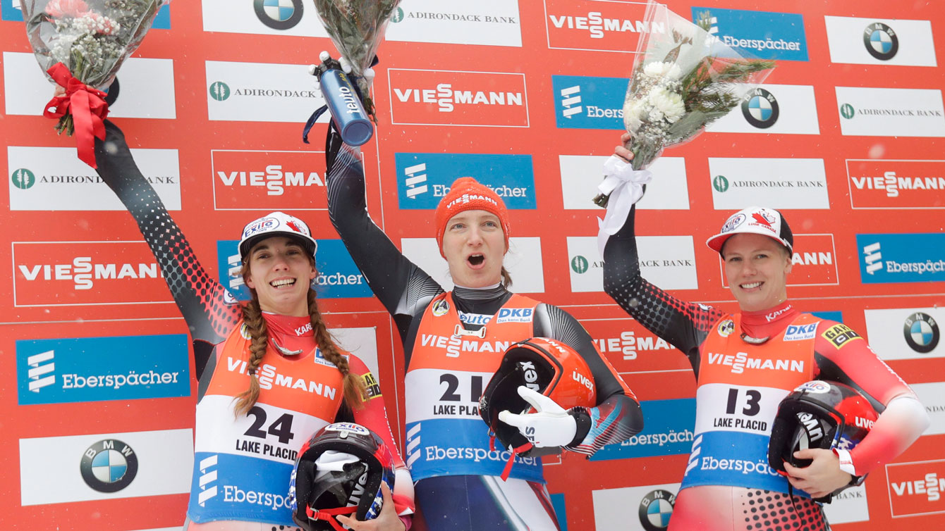 Kimberley McRae and Alex celebrate on the World Cup podium on Saturday, Dec. 3, 2016, in Lake Placid. (AP Photo/Mike Groll)