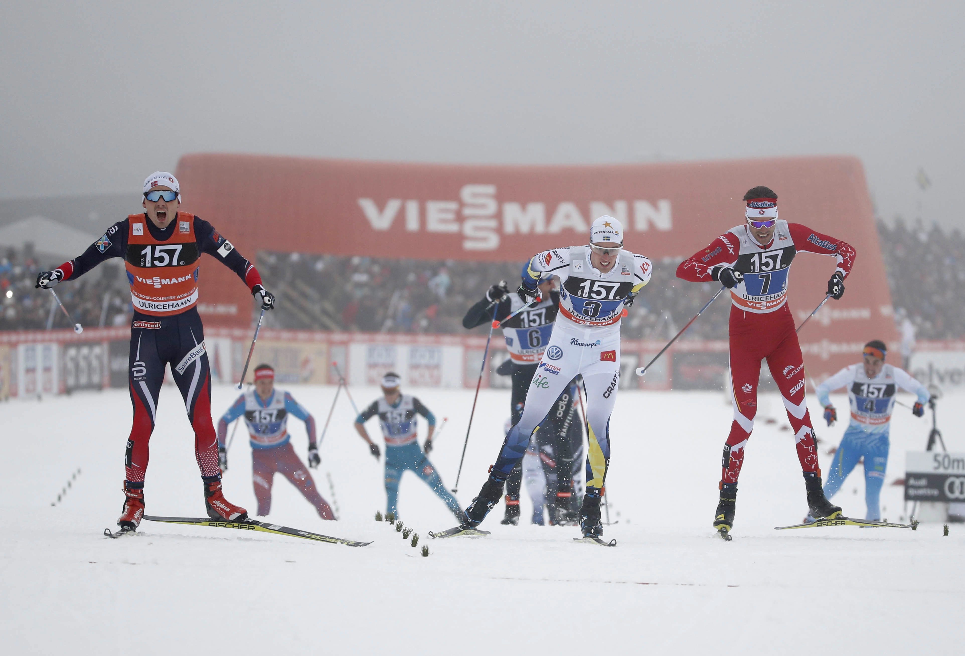 Norway's Finn Haagen Krogh, left, wins in front of Sweden's Calle Halfvarsson, centre, and Len Valjas of Canada, right, during men's relay 4x7.5 km competition at the FIS Cross Country skiing World Cup event in Ulricehamn, Sweden, Sunday Jan. 22, 2017. (Adam Ihse / TT via AP)