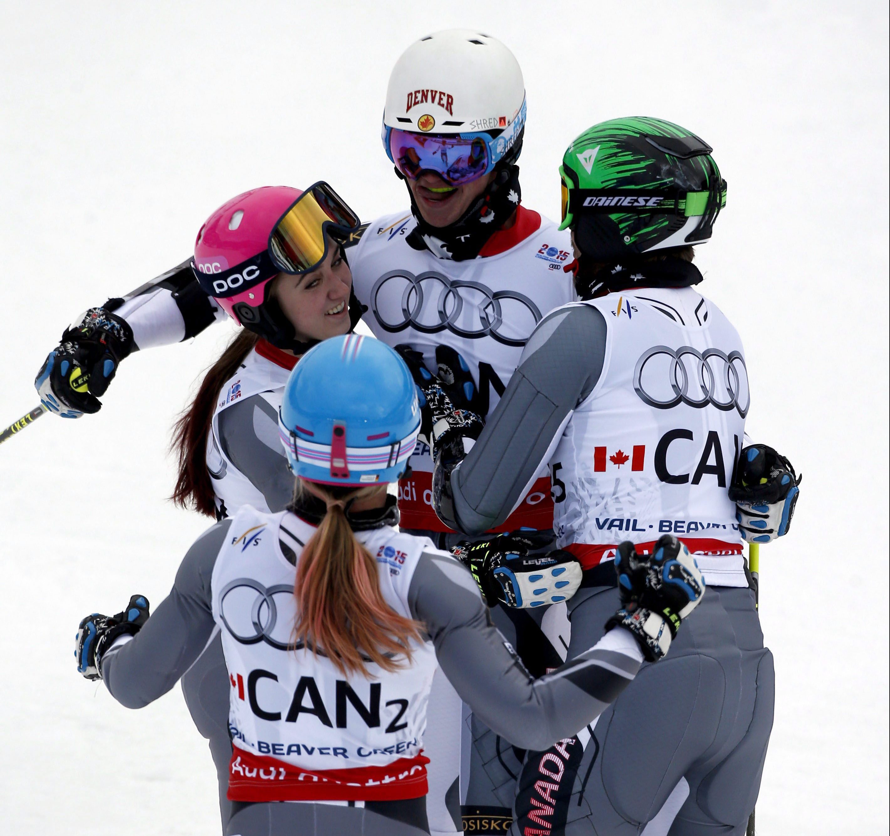 Canada's Trevor Philp, top, Candace Crawford, left, Erin Mielzynski, bottom, and Phil Brown during the mixed worlds team skiing event at the alpine skiing world championships, Tuesday, Feb. 10, 2015, in Vail, Colo. (AP Photo/John Locher)