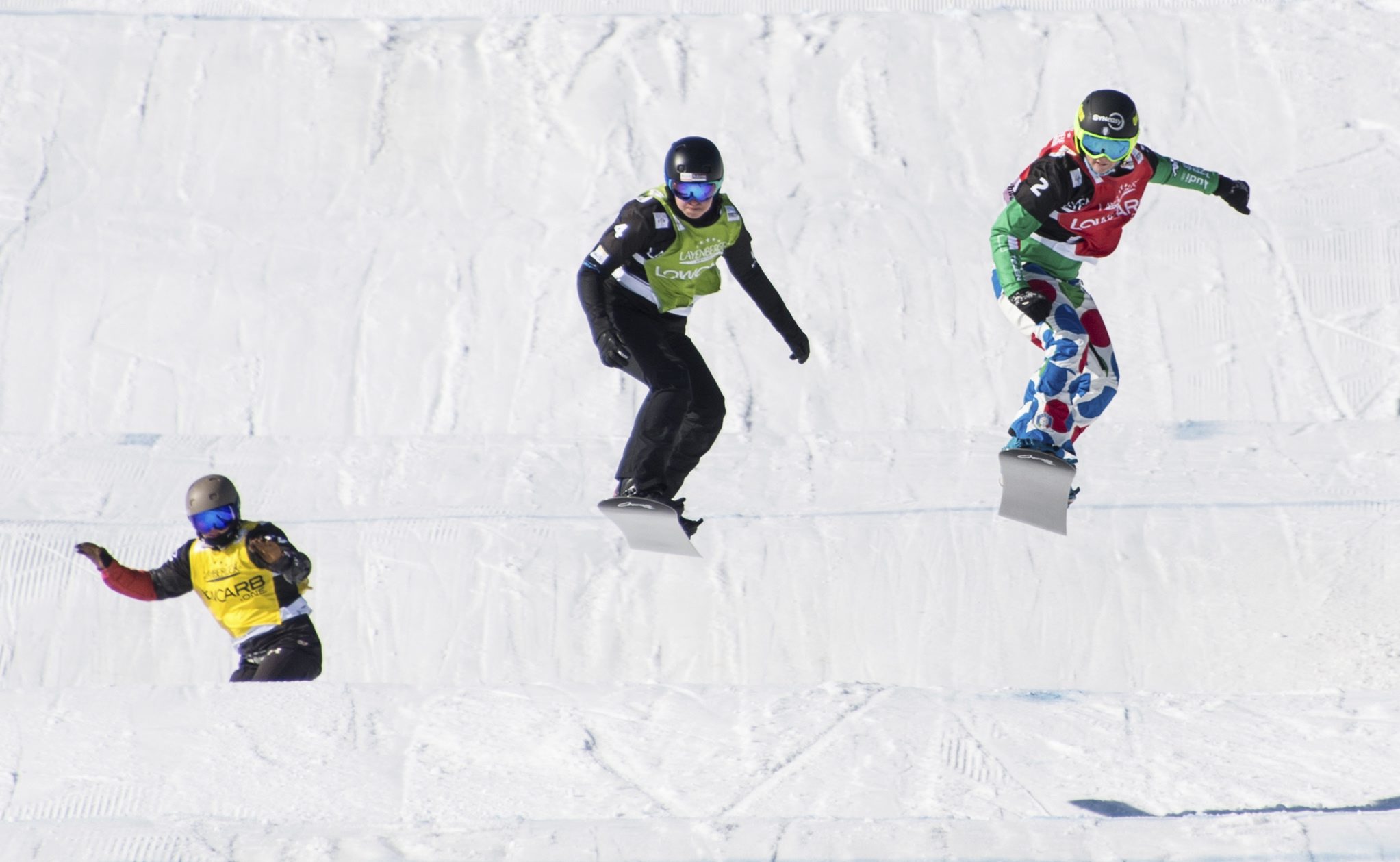 Winner Michaela Moioli from Italy, right, second placed Belle Brockhoff from Australia, center, (2nd place, c) and third placed Meryeta Odine from Canada, left, speed down the track during the Ladies' Snowboard Cross World Cup at Feldberg mountain in the Black Forest region, Germany,, Saturday, Feb. 11, 2017. ( Patrick Seeger/dpa via AP)