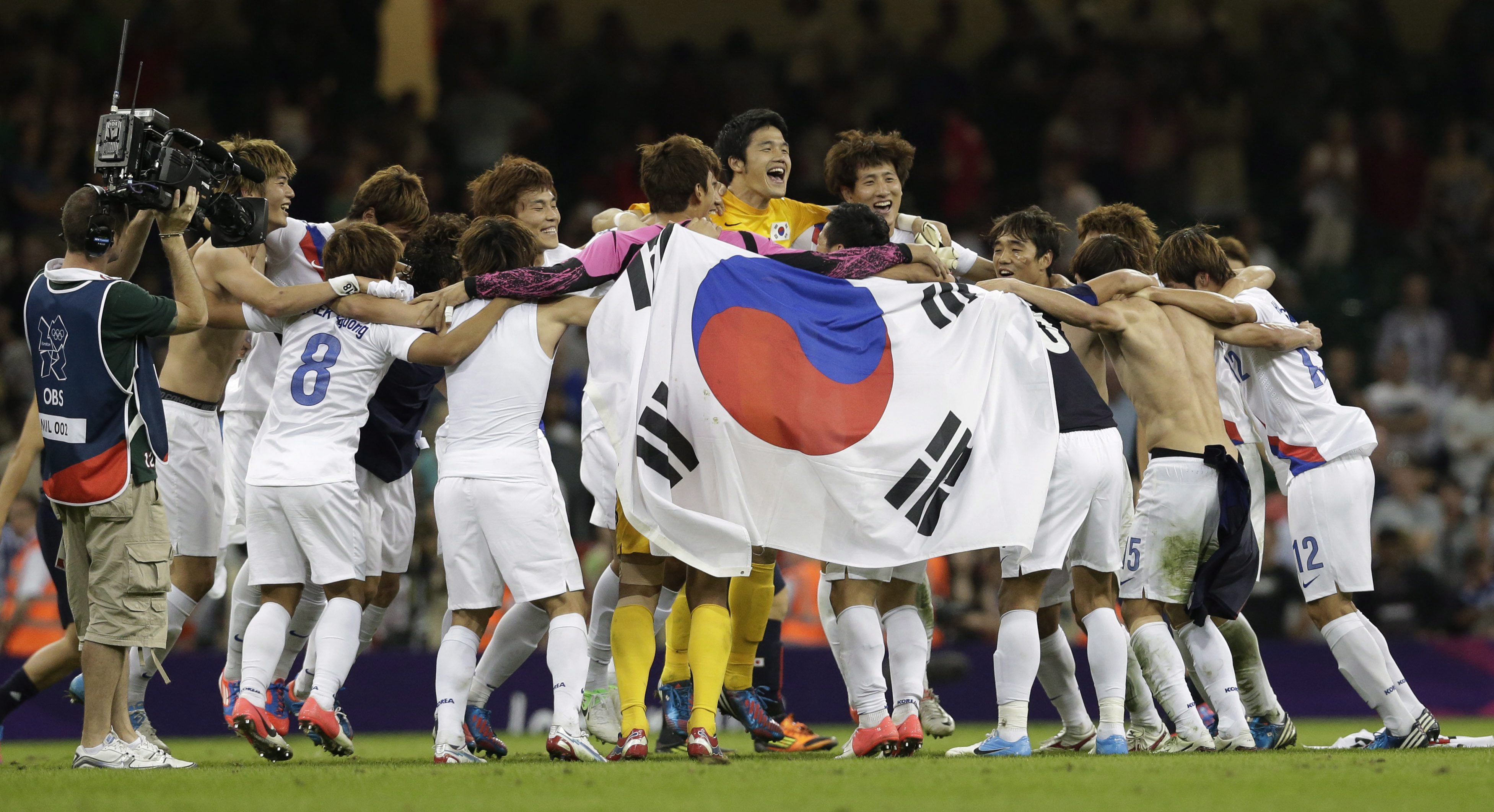 South Korea's players celebrate after winning their men's soccer bronze medal match against Japan, in Cardiff, Wales, at the 2012 London Summer Olympics, Friday, Aug. 10, 2012. South Korea won 2-0. (AP Photo/Luca Bruno)