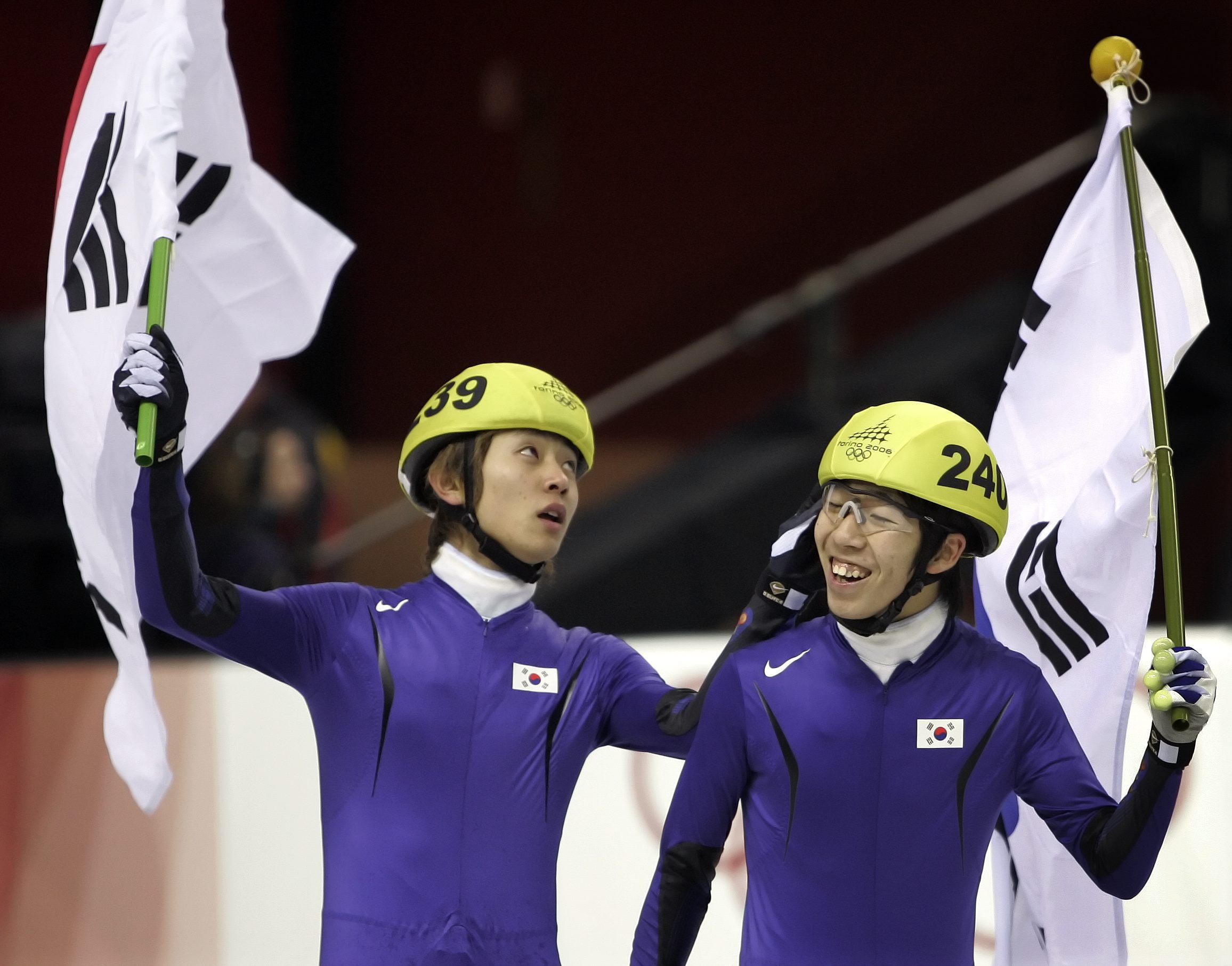Olympic gold medalist Korea's Ahn Hyun-Soo, left, congratulates his teammate silver medalist Lee Ho-Suk after Hyun-So's gold medal victory in the Men's Short Track Speedskating 1500 meter race at the Turin 2006 Winter Olympic Games in Turin, Italy, Sunday, Feb. 12, 2006. (AP Photo/Eric Gay)