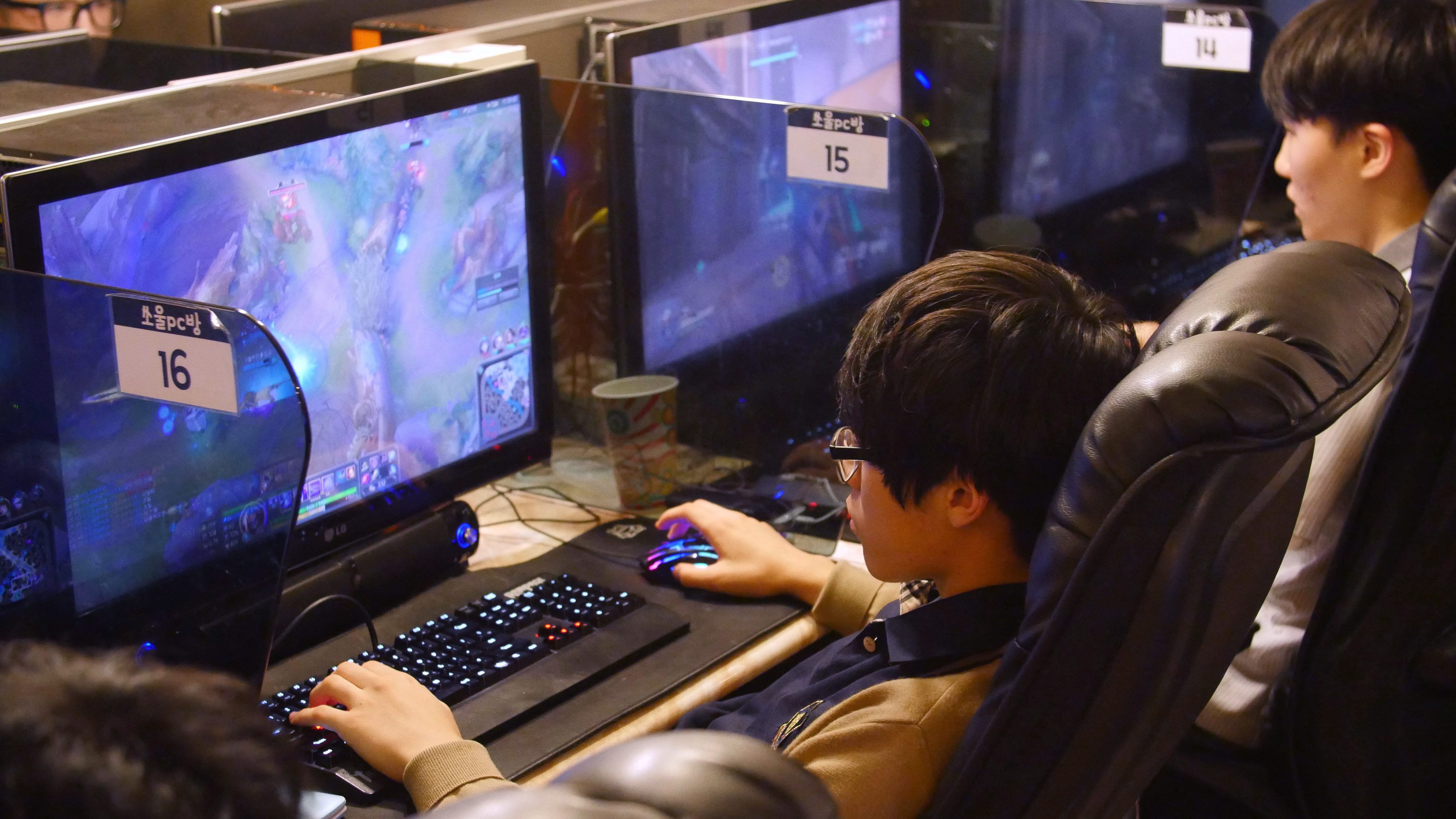 In this Aug. 30, 2016, photo, a man plays a computer game at a PC cafe in Seoul, South Korea. South Korea started the e-sports industry in the early 2000s, and it continues to be a world leader in competitive gaming. There are not only professional video game players, but also broadcasting channels and professional leagues for different kinds of games. South Koreans can easily watch professional gamers playing on both television and the internet. (AP Photo/Jungho Choi)