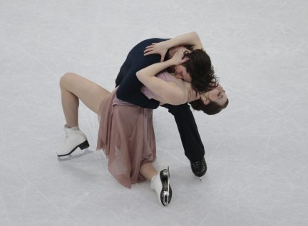 Tessa Virtue and Scott Moir, of Canada, skate their free dance to win the gold at the world figure skating championships in Helsinki, Finland, on Saturday, April 1, 2017. (AP Photo/Ivan Sekretarev)