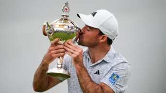 Nick Taylor kisses trophy after winning RBC Canadian Open.