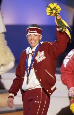 Canada's Beckie Scott, of Vermilion, Alberta acknowledges the crowd after receiving the Olympic bronze medal for her performance in the women's 5km free pursuit at Medals Plaza in downtown Salt Lake City, Feb. 15, 2002. (AP Photo/Darron Cummings)