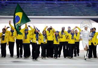 Jaqueline Mourao of Brazil carries the national flag as she leads the team during the opening ceremony of the 2014 Olympic Winter Games in Sochi, Russia, Friday, Feb. 7, 2014. (AP Photo/Mark Humphrey)