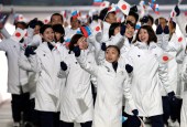 Athletes from Japan wave the Japanese and Russian national flags as they arrive during the opening ceremony of the 2014 Olympic Winter Games in Sochi, Russia, Friday, Feb. 7, 2014. (AP Photo/Mark Humphrey)