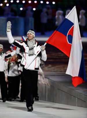 Zdeno Chara of Slovakia waves as he carries the flag as he leads the team during the opening ceremony of the 2014 Olympic Winter Games in Sochi, Russia, Friday, Feb. 7, 2014. (AP Photo/Mark Humphrey)