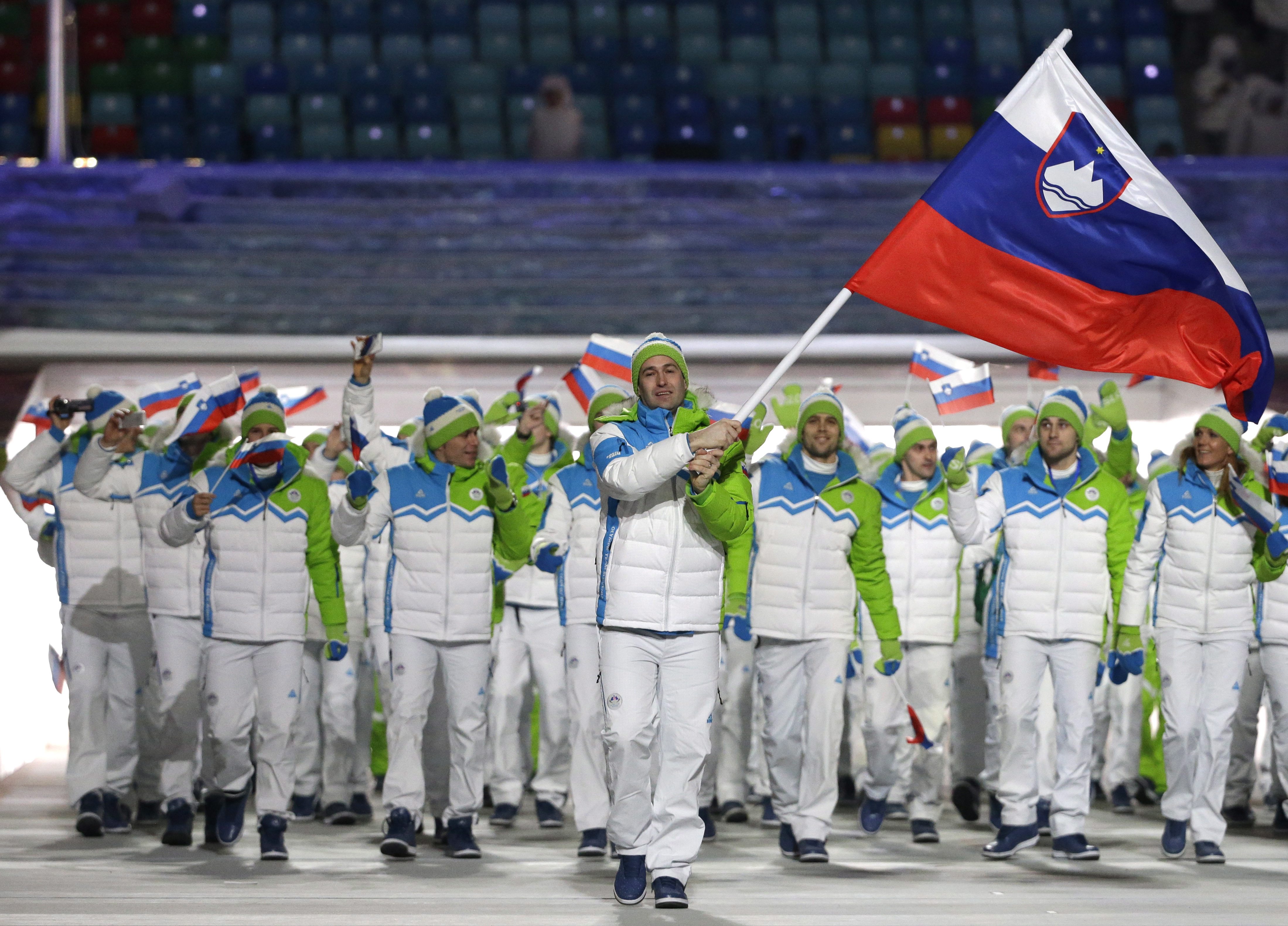 Tomaz Razingar of Slovenia carries the national flag as he leads the team during the opening ceremony of the 2014 Olympic Winter Games in Sochi, Russia, Friday, Feb. 7, 2014. (AP Photo/Mark Humphrey)