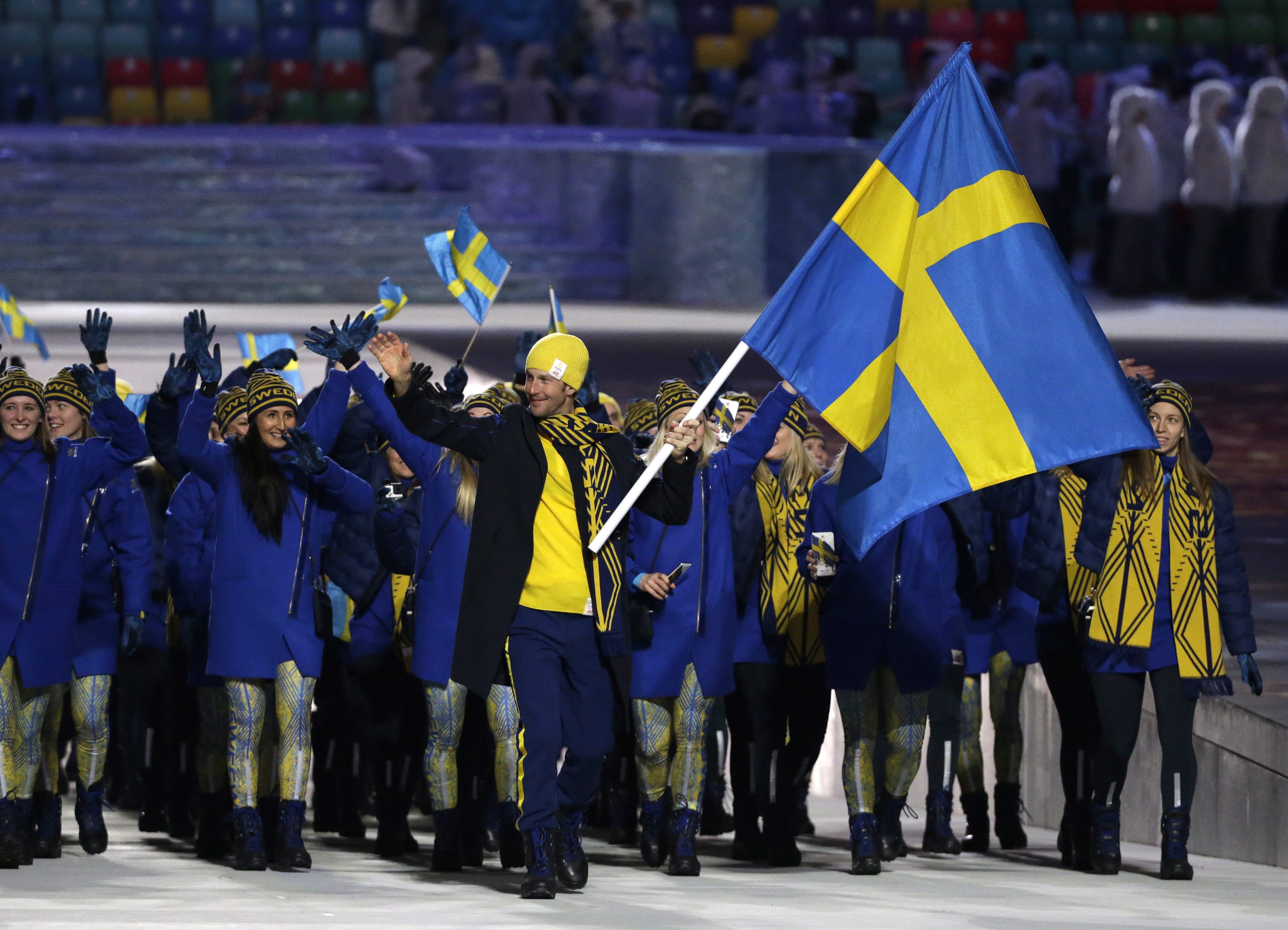 Anders Soedergren of Sweden carries the national flag as he leads the team during the opening ceremony of the 2014 Olympic Winter Games in Sochi, Russia, Friday, Feb. 7, 2014. (AP Photo/Mark Humphrey)