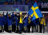 Anders Soedergren of Sweden carries the national flag as he leads the team during the opening ceremony of the 2014 Olympic Winter Games in Sochi, Russia, Friday, Feb. 7, 2014. (AP Photo/Mark Humphrey)