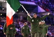 Conor Lyne of Ireland carries his country flag as the Irish team arrives during the opening ceremony of the 2014 Olympic Winter Games in Sochi, Russia, Friday, Feb. 7, 2014. (AP Photo/Matt Dunham)