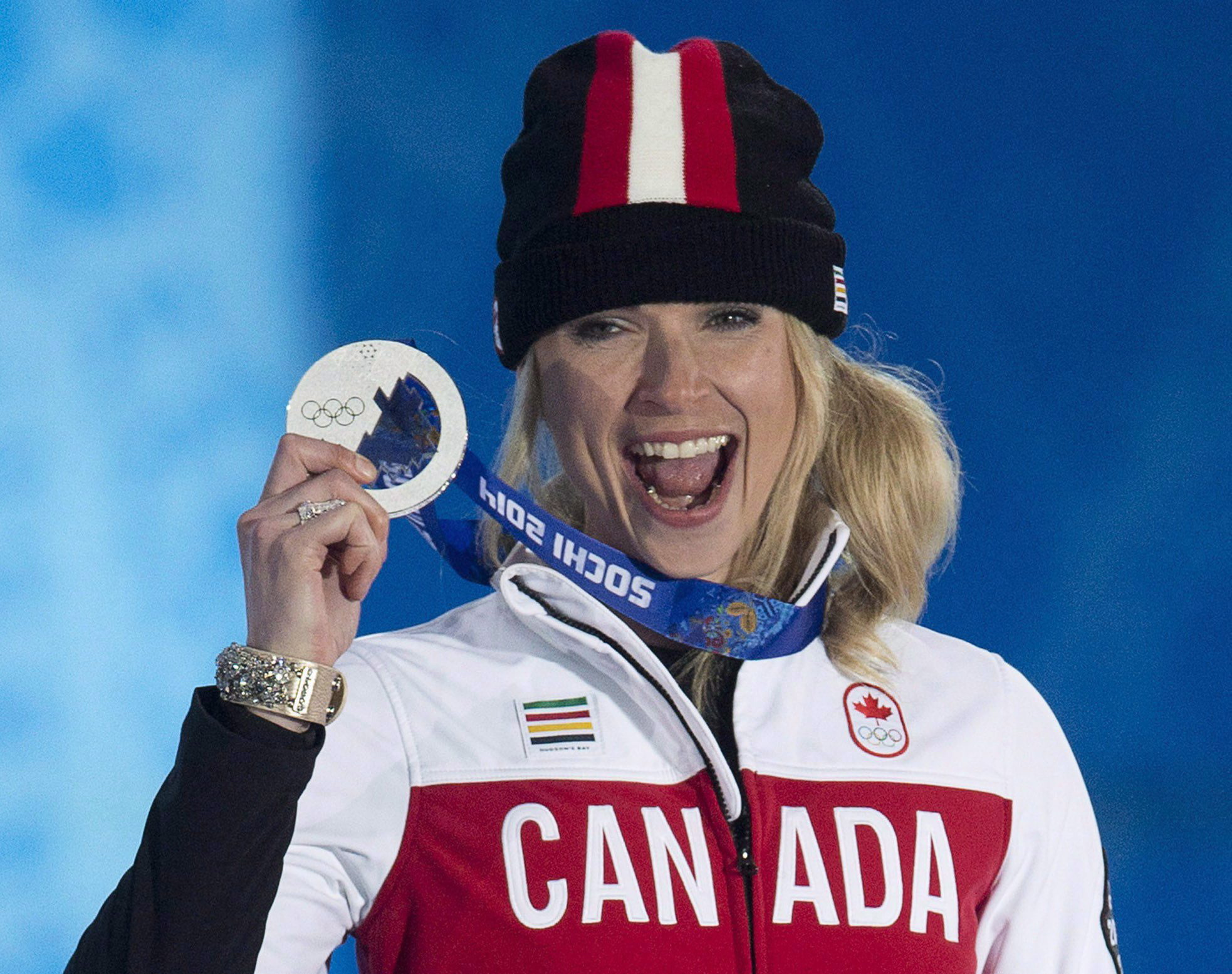 Canada's Dominique Maltais holds up her silver medal for Ladies' Snowboard Cross during the medal ceremony at the Sochi 2014 Olympic Winter Games Sunday February 16, 2014 in Sochi, Russia. THE CANADIAN PRESS/Adrian Wyld
