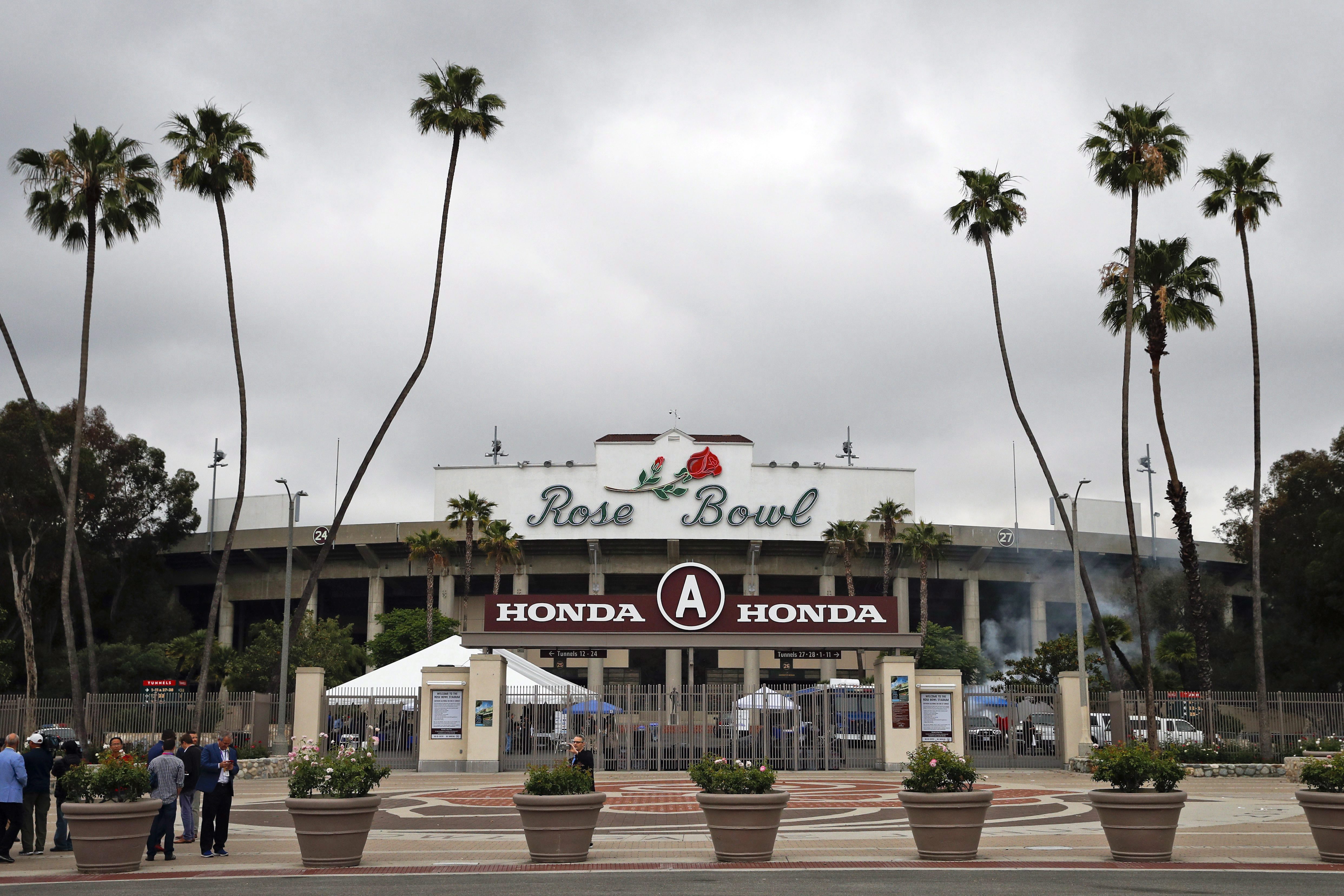 Members of the media gather outside the Rose Bowl Stadium, a proposed Olympic venue, Wednesday, May 10, 2017, in Pasadena, California. (AP Photo/Jae C. Hong)