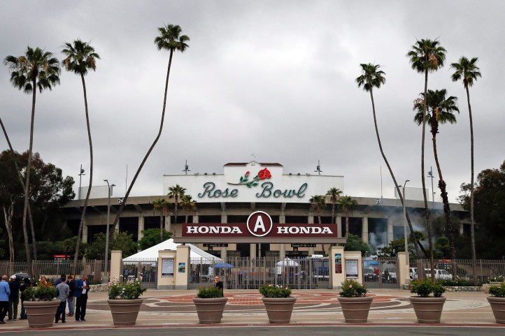 Members of the media gather outside the Rose Bowl Stadium, a proposed Olympic venue, Wednesday, May 10, 2017, in Pasadena, California. (AP Photo/Jae C. Hong)