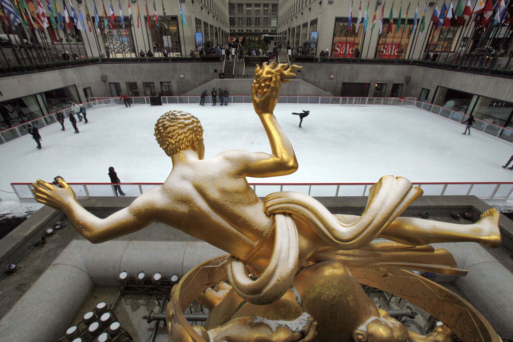 The snow-covered statue of Prometheus overlooks the ice skating rink in New York's Rockefeller Center, Friday, Jan. 8, 2010. (AP Photo/Richard Drew)