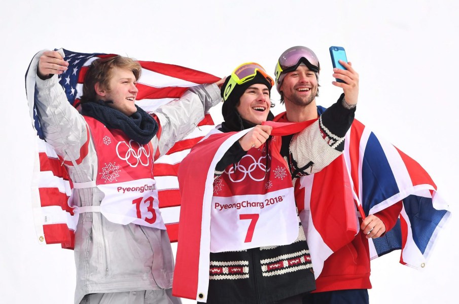 OLY SBD Big Air Canada 20180224 Gold medallist Sebastien Toutant of Canada, centre, takes a selfie with silver medallist Kyle Mack of the United States, left, and bronze medallist Billy Morgan of Great Britain celebrate following the men's snowboard big air final at the 2018 Winter Olympic Games in Pyeongchang, South Korea, Saturday, Feb. 24, 2018. THE CANADIAN PRESS/Jonathan Hayward