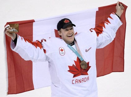 OLY HKO Canada Czech Republic 20180224 Canada goaltender Justin Peters (35) holds the flag up as the team celebrates their win following third period men's hockey bronze medal game action against Czech Republic at the 2018 Olympic Winter Games, in Pyeongchang, South Korea, on Saturday, February 24, 2018. THE CANADIAN PRESS/Nathan Denette