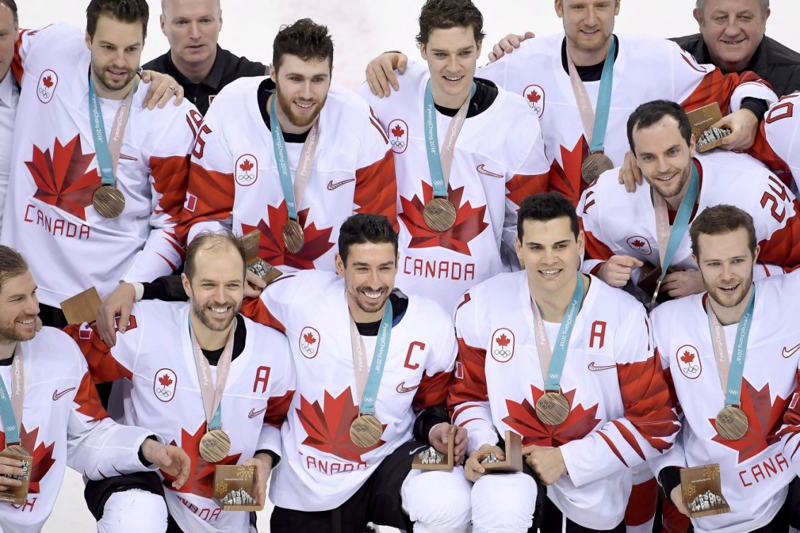 Team Canada men's hockey pose with their bronze medals 