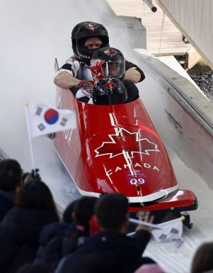 Driver Justin Kripps, Jesse Lumsden, Alexander Kopacz and Oluseyi Smith of Canada finish their third heat during the four-man bobsled competition final at the 2018 Winter Olympics in Pyeongchang, South Korea, Sunday, Feb. 25, 2018. (AP Photo/Patrick Semansky)