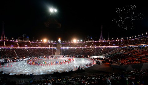 Athletes march into the stadium as an Olympic mascot is illuminated in the sky during the closing ceremony of the 2018 Winter Olympics in Pyeongchang, South Korea, Sunday, Feb. 25, 2018. (AP Photo/Chris Carlson)