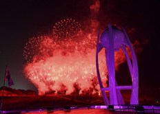 Fireworks explode near the Olympic cauldron at the end of the closing ceremony of the 2018 Winter Olympics in Pyeongchang, South Korea, Sunday, Feb. 25, 2018. (Florien Choblet/Pool Photo via AP)