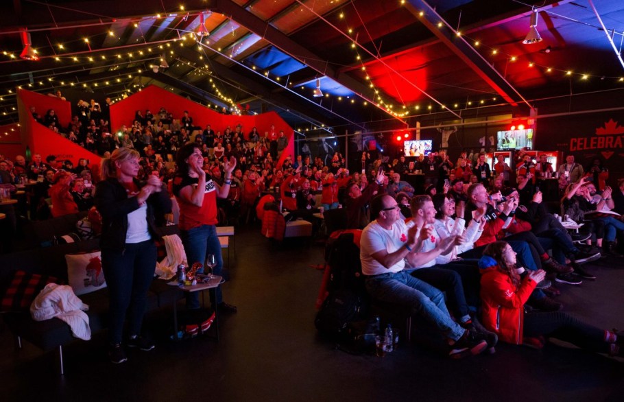 People gather at Canada Olympic House to watch the opening ceremony