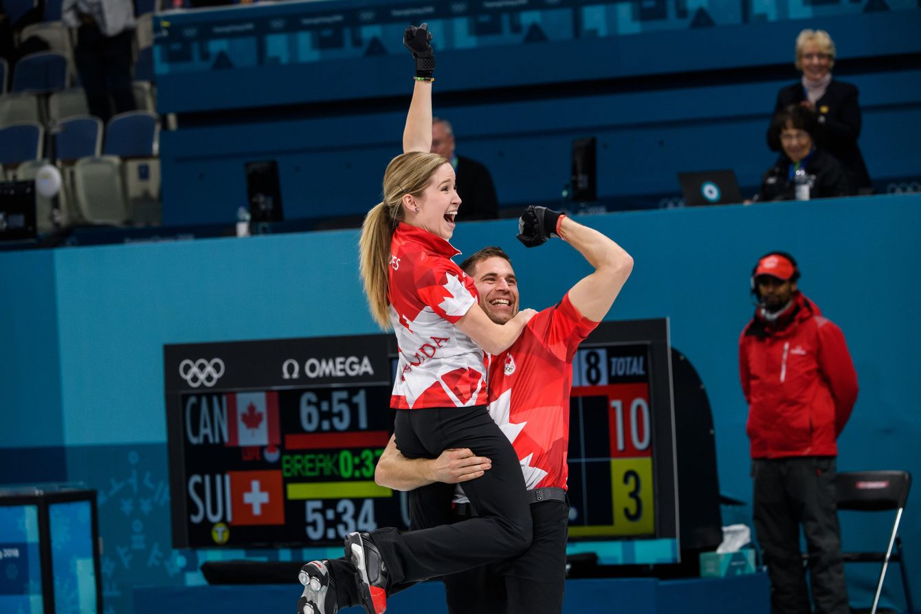Kaitlyn Lawes and John Morris after clinching mixed doubles curling gold at PyeongChang 2018. (Photo by Vincent Ethier/COC)