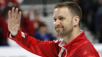 Brad Gushue waves to the crowd after a match