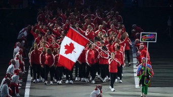 Team Canada flag bearer leads Team Canada through opening ceremonies at the Lima 2019 Pan American Games