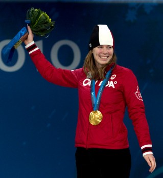 Canadian speedskater Christine Nesbitt, from London, Ont., stands on the podium after receiving her gold medal for the women's long-track 1,000m competition during the medal ceremonies in Vancouver, BC Thursday Feb. 18, 2010. THE CANADIAN PRESS/Adrian Wyld