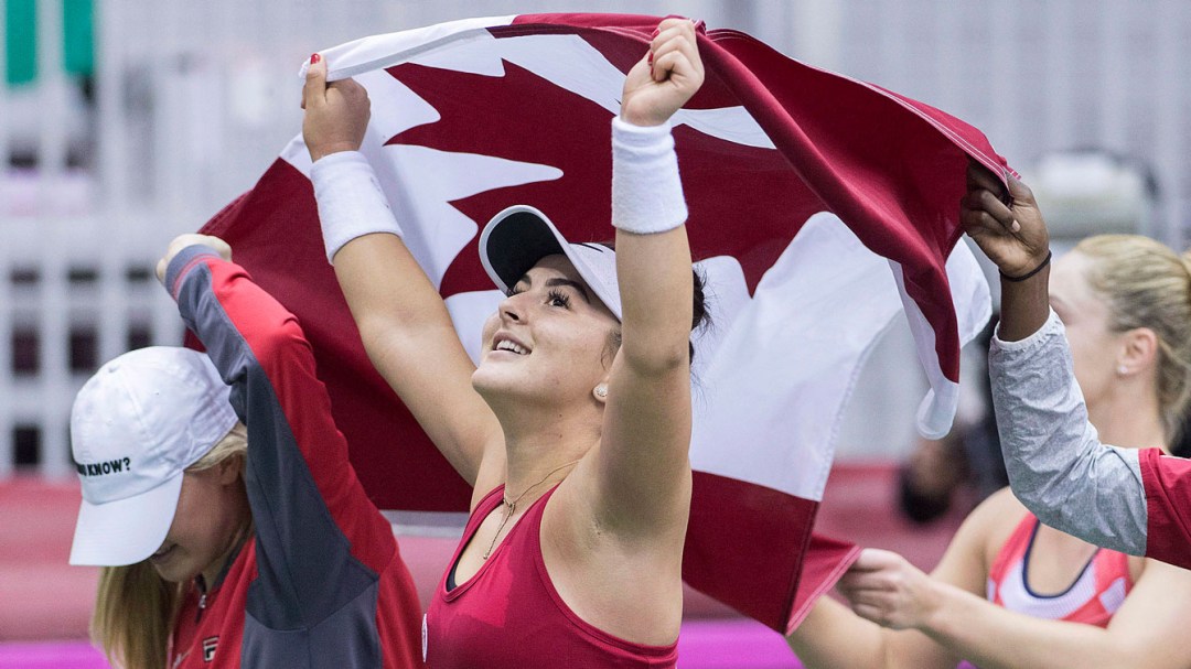 Bianca Andreescu celebrates with a Canadian flag over her head