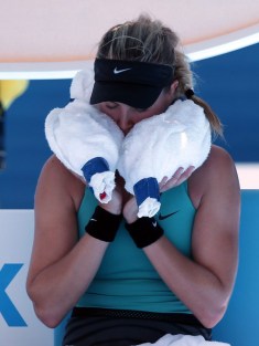 Eugenie Bouchard using ice in a towel to cool off at the 2014 Australian Open. (AP Photo/Aijaz Rahi)