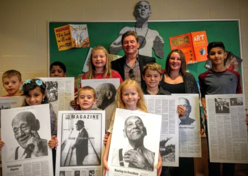 Students pose with Ray Lewis archives at the eponymous elementary school's library in Hamilton, Ontario. (Photo: Hamilton Spectator).