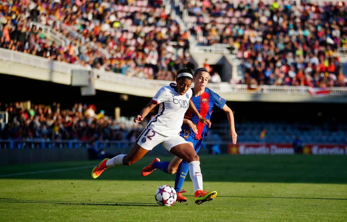 PSG's Ashley Lawrence, left, duels for the ball against FC Barcelona's Barbara Latorre during the Women's Champions League semifinal first leg soccer match between FC Barcelona and Paris Saint Germain, at the Miniestadi stadium in Barcelona, Spain, Saturday, April 22, 2017. (AP Photo/Manu Fernandez)