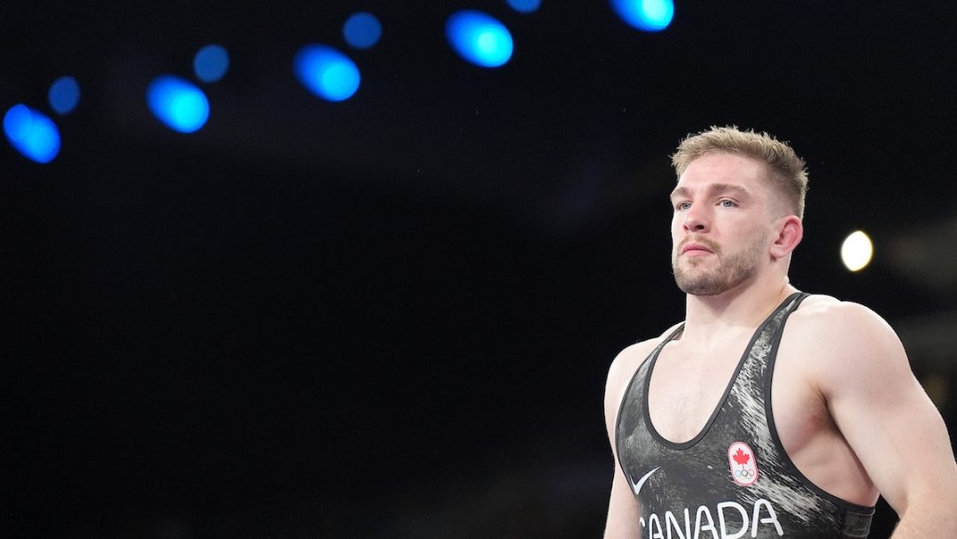 Alex Moore wears a black Team Canada singlet