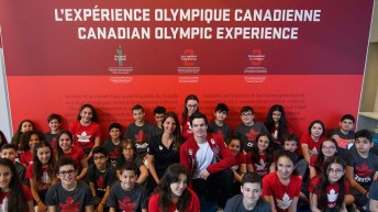 Olympic athletes sitting with children