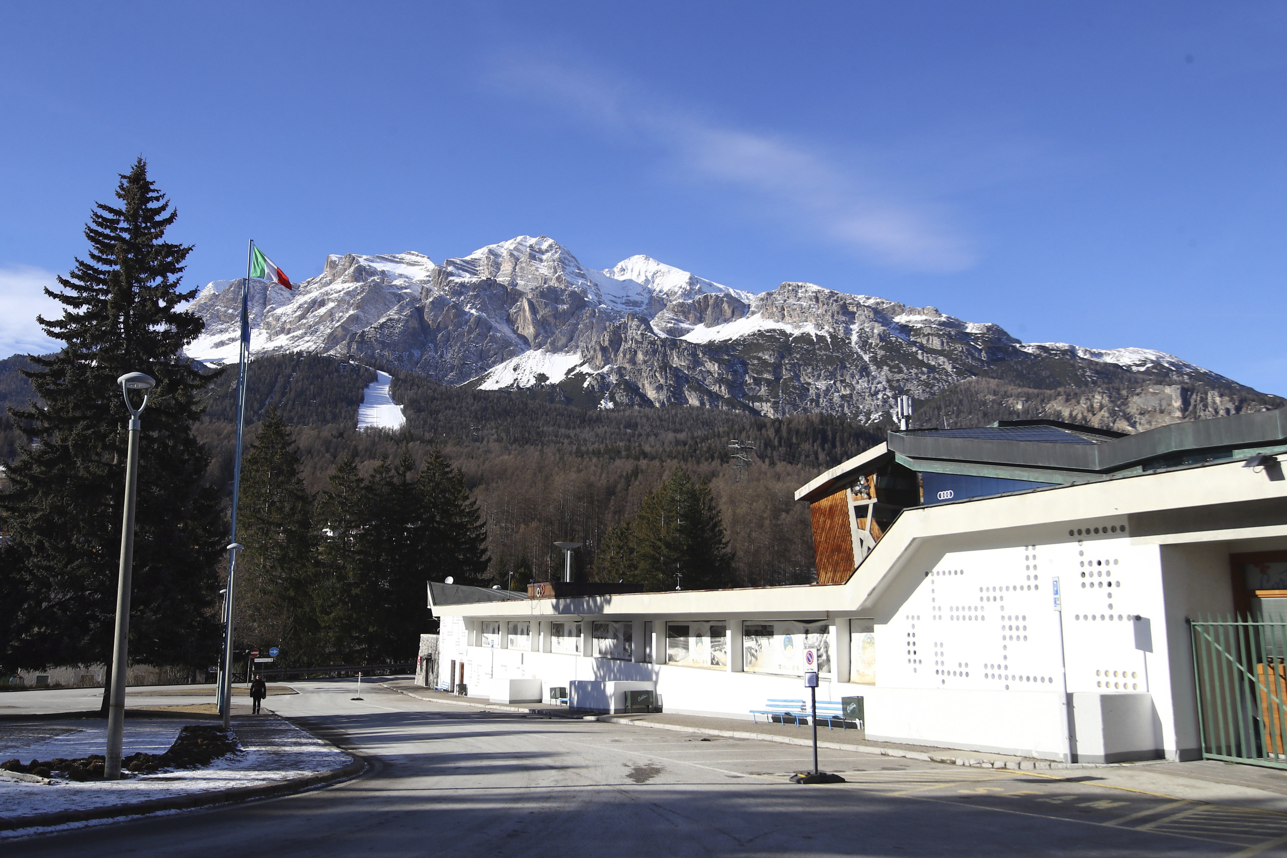picture of building with snow covered mountain behind
