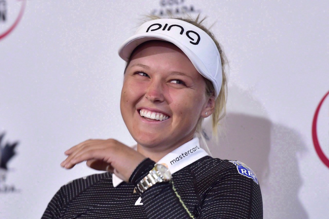 Brooke Henderson laughs at a press conference 