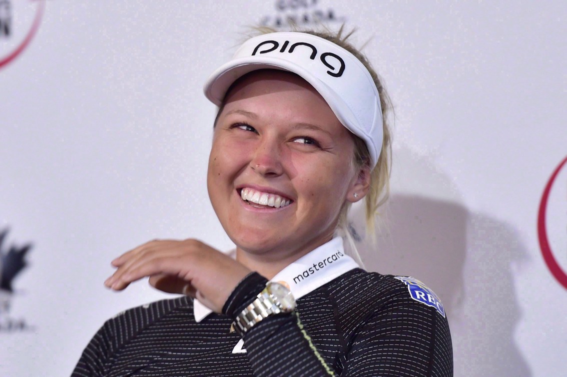 Brooke Henderson laughs at a press conference