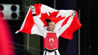 Skylar Park hoists a Canadian flag over her shoulders