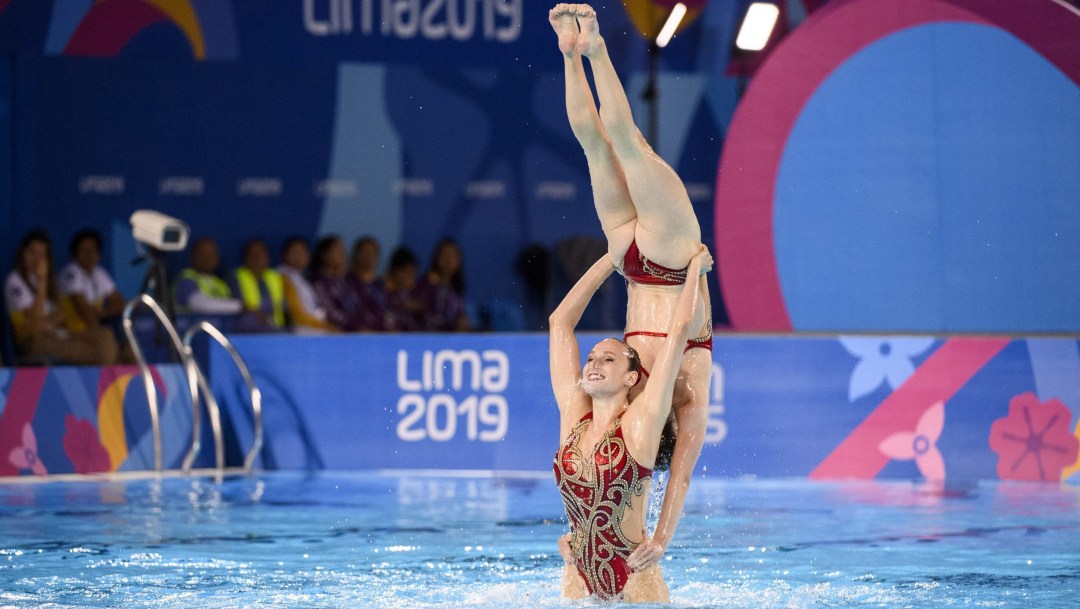 Two artistic swimmers performing a lift