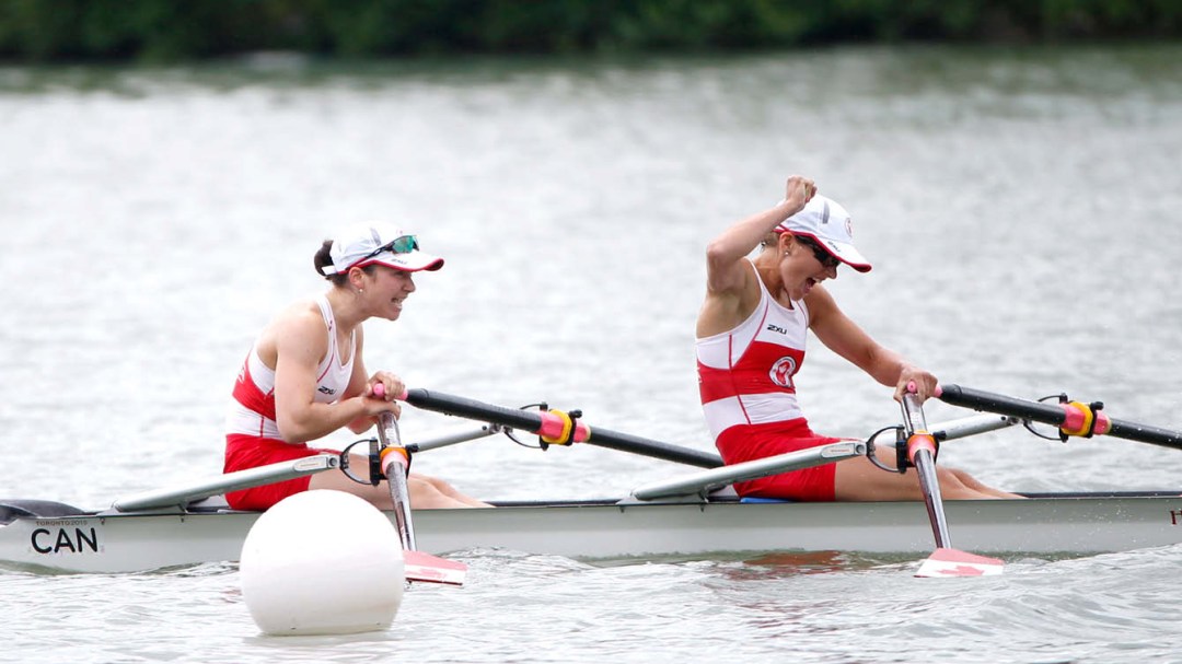 Rowers in boat celebrating