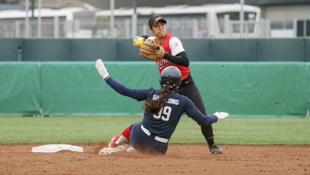 Janet Leung of Canada plays the ball against the United States in the women's softball final at the Lima 2019 Pan American Games