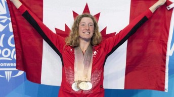 Taylor Ruck poses for photos with her eight swimming medals