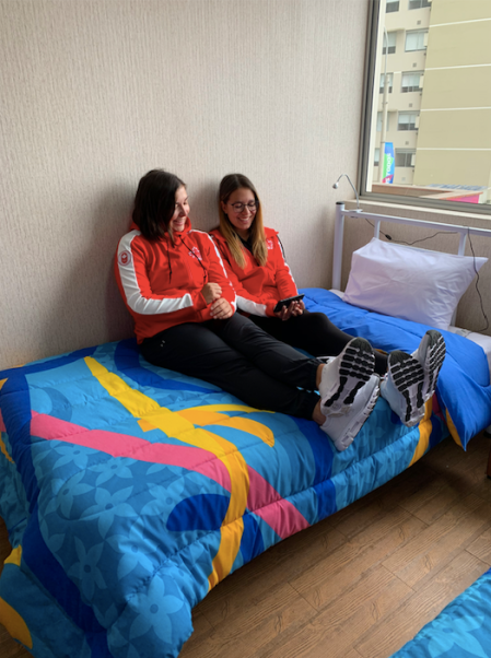 Athletes hanging out in their room at the village