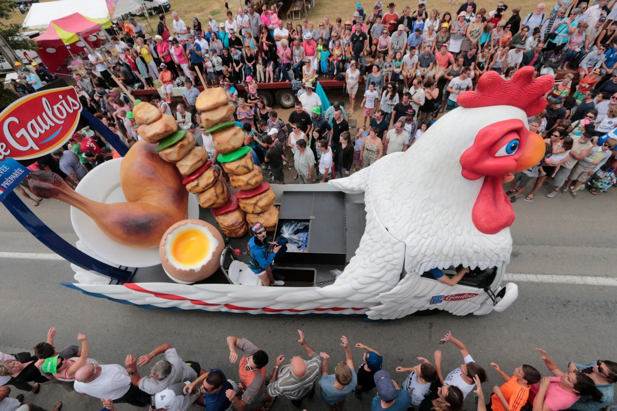 Caravan passes through Tour de France as spectators watch