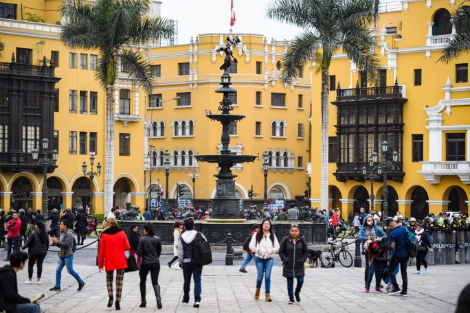 Plaza de Armas Lima Peru Yellow buildings with palm trees